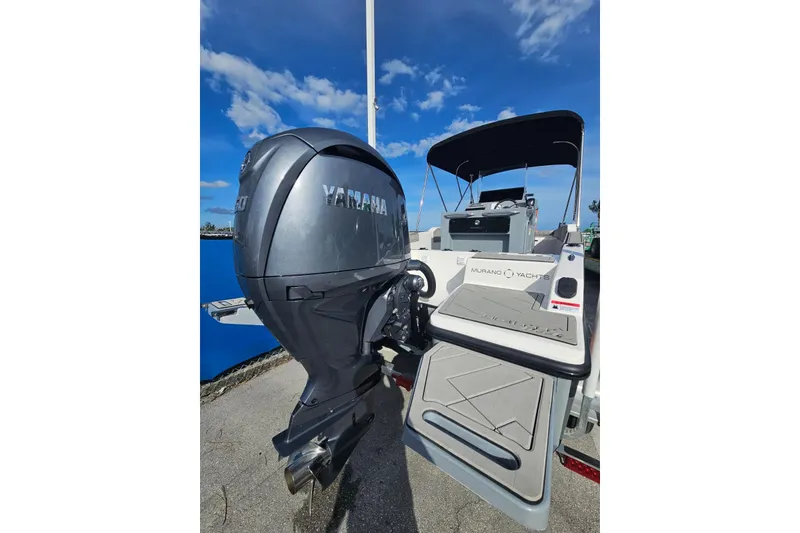 Slide: The Image of 2026 Murano 205 yacht with Yamaha outboard motor, docked under clear blue sky. - 25