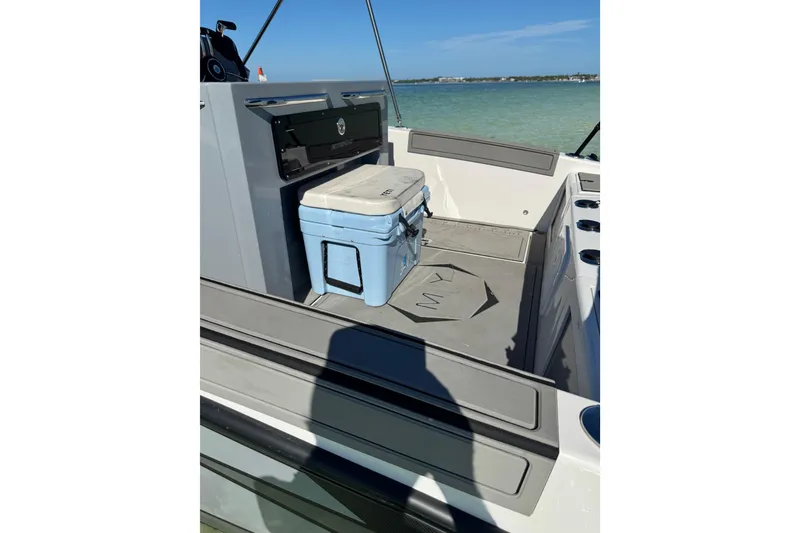 Slide: The Image of 2026 Murano 205 boat interior with cooler, on calm water. - 6