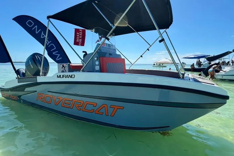 Slide: The Image of 2026 Murano 205 Rovercat boat with canopy, floating in clear water, for sale. - 5