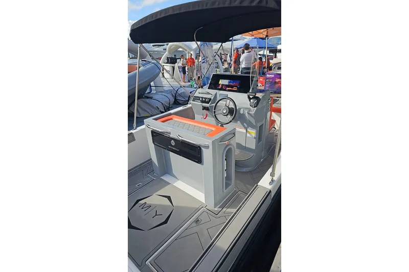 Slide: The Image of 2026 Murano 205 boat interior with modern dashboard and steering wheel, showcased at a boat event. - 19