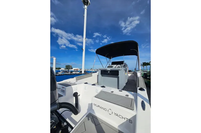 Slide: The Image of 2026 Murano 205 yacht with sleek design, docked under a clear blue sky. - 27