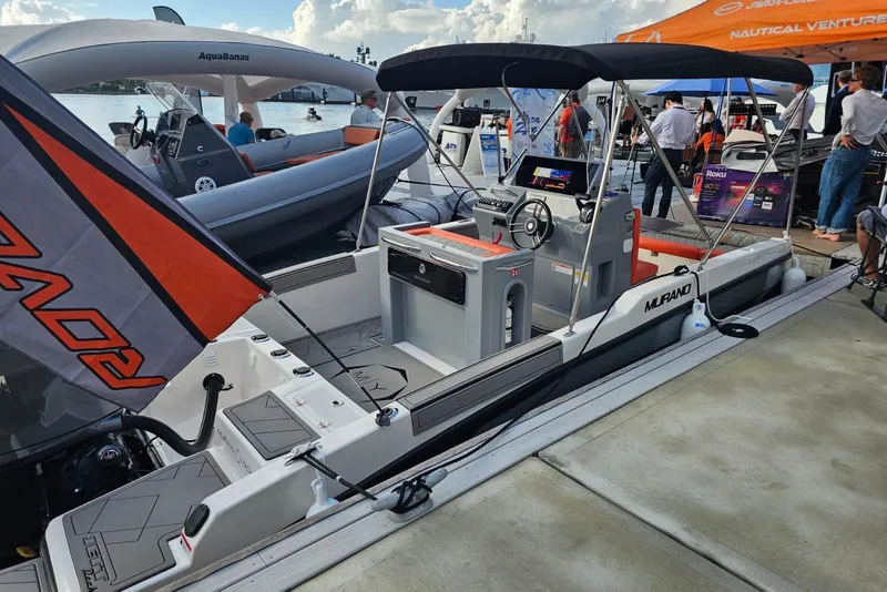 Slide: The Image of 2026 Murano 205 boat displayed at a nautical event, featuring modern design and amenities. - 23