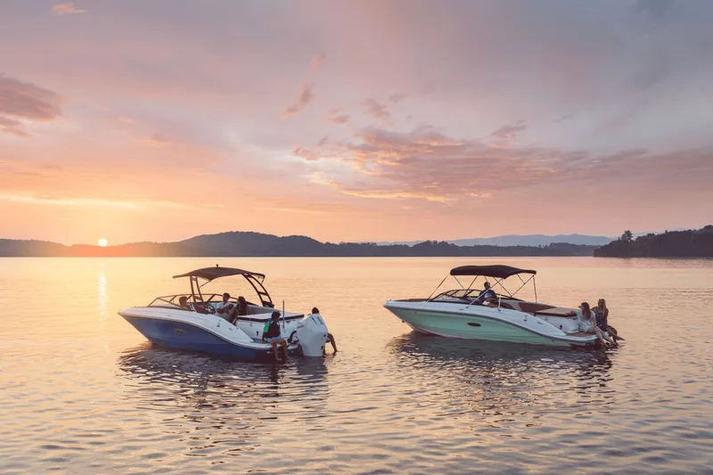 Slide: The Image of Two Sea Ray SPX 230 boats float on calm water at sunset. - 19