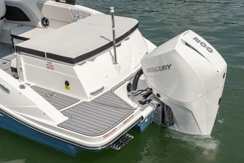 Slide: The Image of The image shows the rear of a 2024 Sea Ray SPX 230 Outboard boat with a Mercury outboard motor. - 14