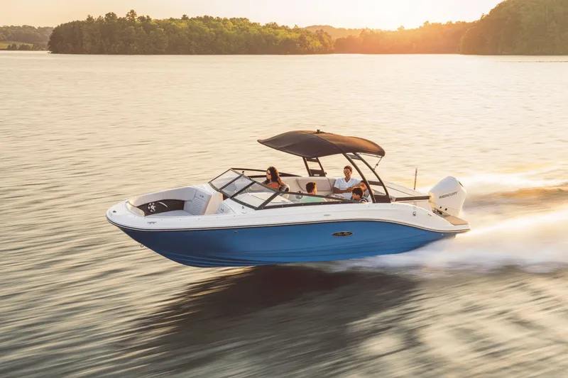 Slide: The Image of A 2024 Sea Ray SPX 230 Outboard speeds across calm water at sunset. - 15