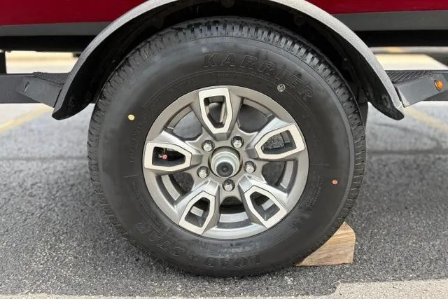Slide: The Image of 2025 Tracker Off Road Pro Team 175 wheel on a wooden block, close-up view. - 49