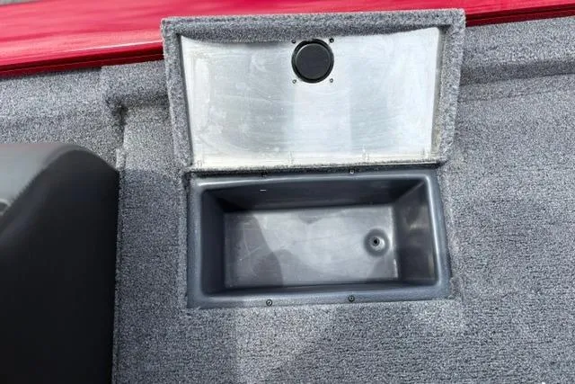 Slide: The Image of Storage compartment in 2025 Tracker Off Road Pro Team 175 boat, featuring gray interior. - 23