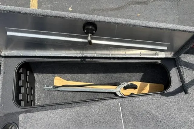 Slide: The Image of 2025 Tracker Off Road Pro Team 175 boat storage compartment with paddle and clamp. - 14