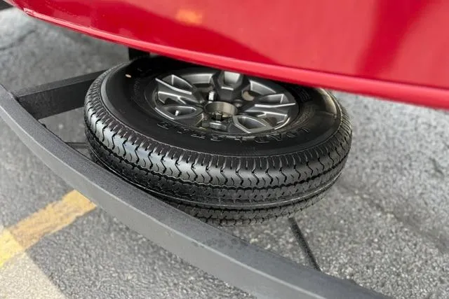 Slide: The Image of 2025 Tracker Off Road Pro Team 175 trailer tire on pavement. - 51