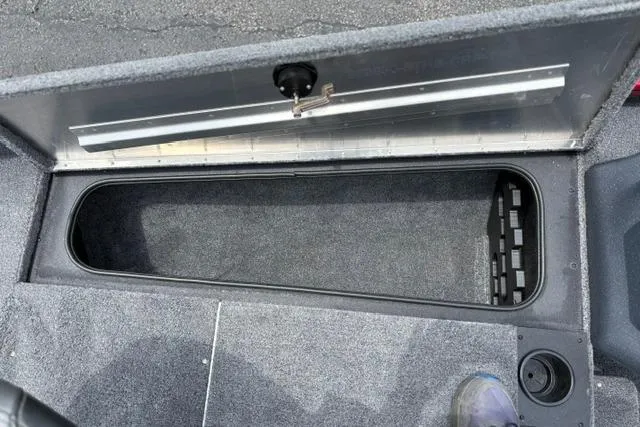 Slide: The Image of Storage compartment of 2025 Tracker Off Road Pro Team 175 boat, open and empty. - 33