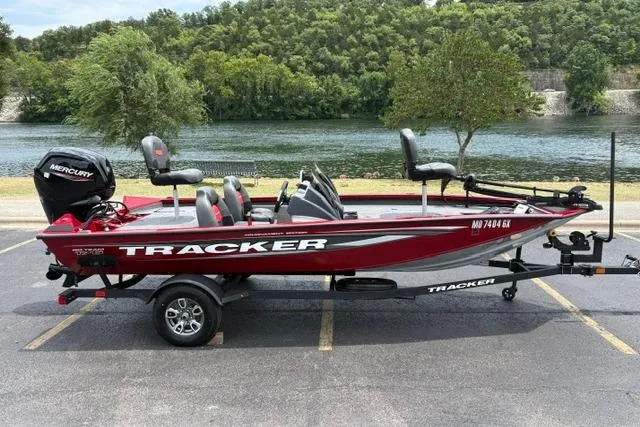 Slide: The Image of 2025 Tracker Off Road Pro Team 175 boat parked by a scenic river. - 3