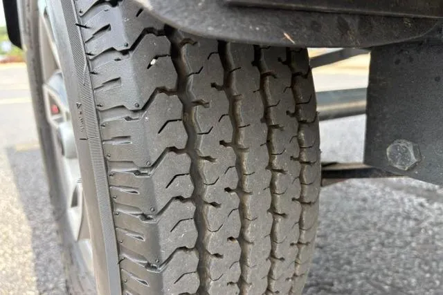 Slide: The Image of Close-up of a 2025 Tracker Off Road Pro Team 175 tire on pavement. - 50