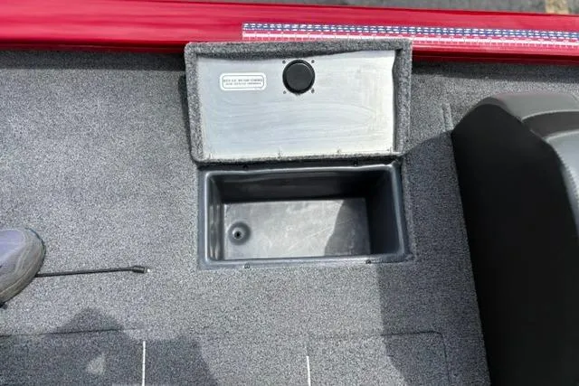 Slide: The Image of 2025 Tracker Off Road Pro Team 175 boat interior storage compartment with gray carpet. - 24