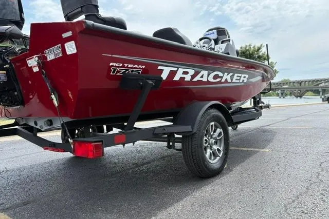 Slide: The Image of 2025 Tracker Off Road Pro Team 175 boat on trailer, parked in a lot near water. - 8