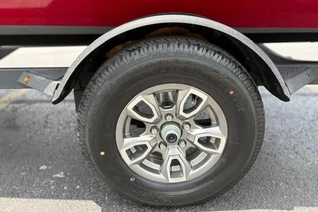 Slide: The Image of 2025 Tracker Off Road Pro Team 175 trailer wheel and tire close-up. - 47