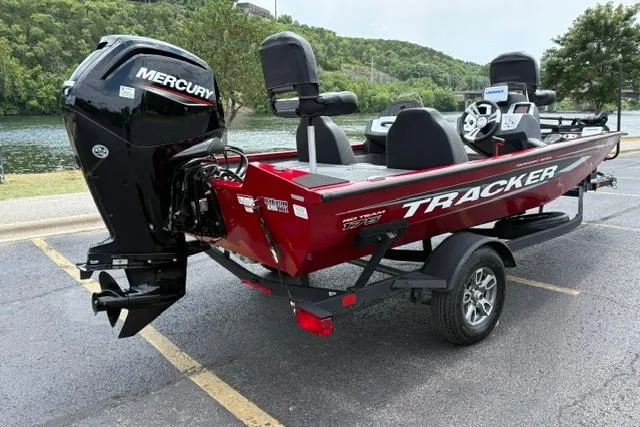 Slide: The Image of 2025 Tracker Off Road Pro Team 175 boat with Mercury engine, parked near a scenic lake. - 10
