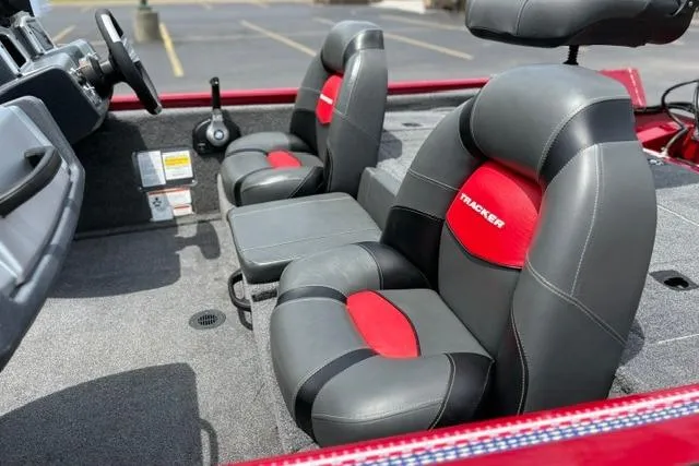 Slide: The Image of 2025 Tracker Off Road Pro Team 175 boat interior with gray and red seating. - 27