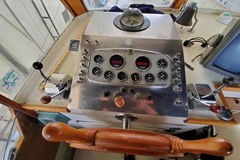 Slide: The Image of Control panel of a 1971 Monk 44 Express Bridge boat with gauges and levers. - 6