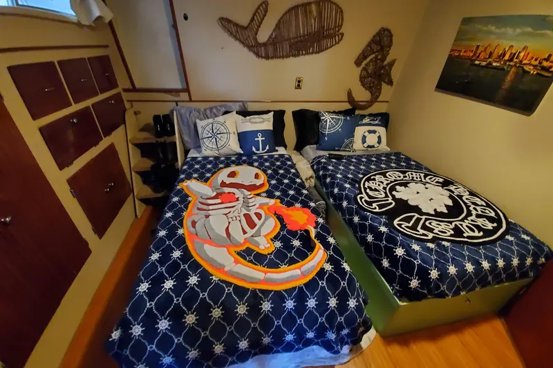 Slide: The Image of Cozy cabin bedroom in 1971 Monk 44 Express Bridge with nautical decor and twin beds. - 4