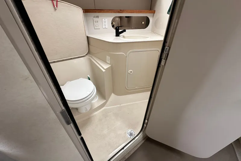 Slide: The Image of 1995 Cruisers Yachts 3575 Esprit bathroom with toilet, sink, and mirror. - 27