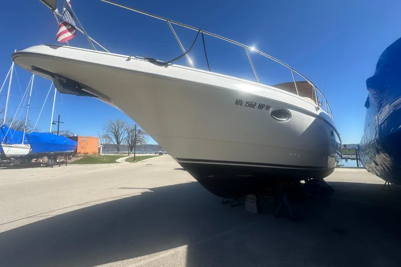 Slide: The Image of 1995 Cruisers Yachts 3575 Esprit boat on dry dock under clear blue sky. - 20