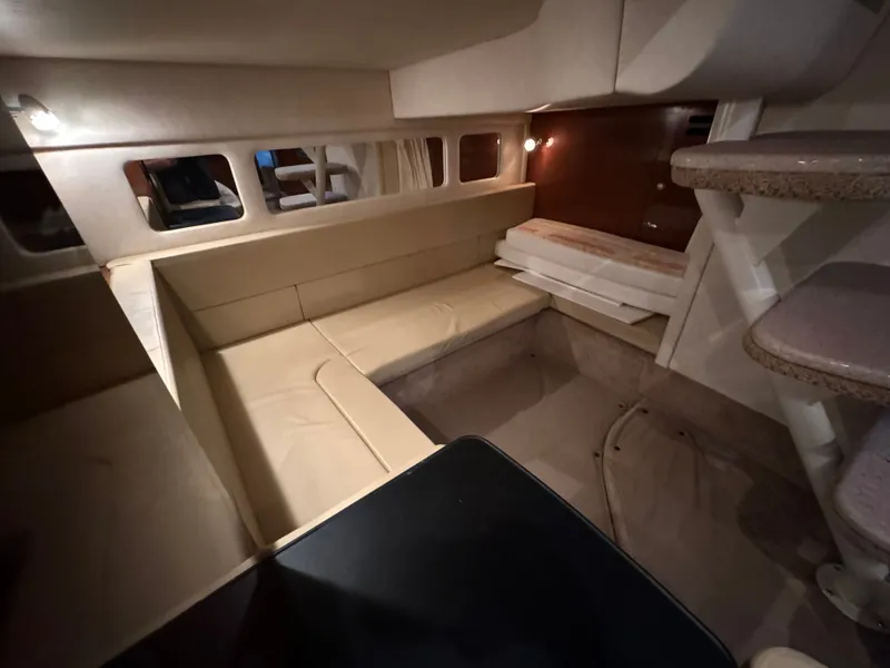 Slide: The Image of Interior of a 2008 Sea Ray Sundancer 310 with beige seating area and stairs. - 34