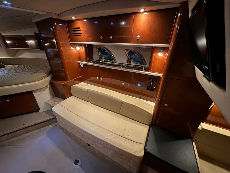 Slide: The Image of Interior of a 2008 Sea Ray Sundancer 310 with elegant wood furnishings and a beige sofa. - 30