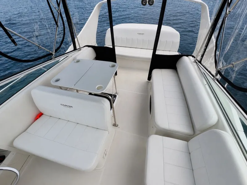 Slide: The Image of The image shows the cockpit of a 1998 Carver 35 with white seating and a table. - 7