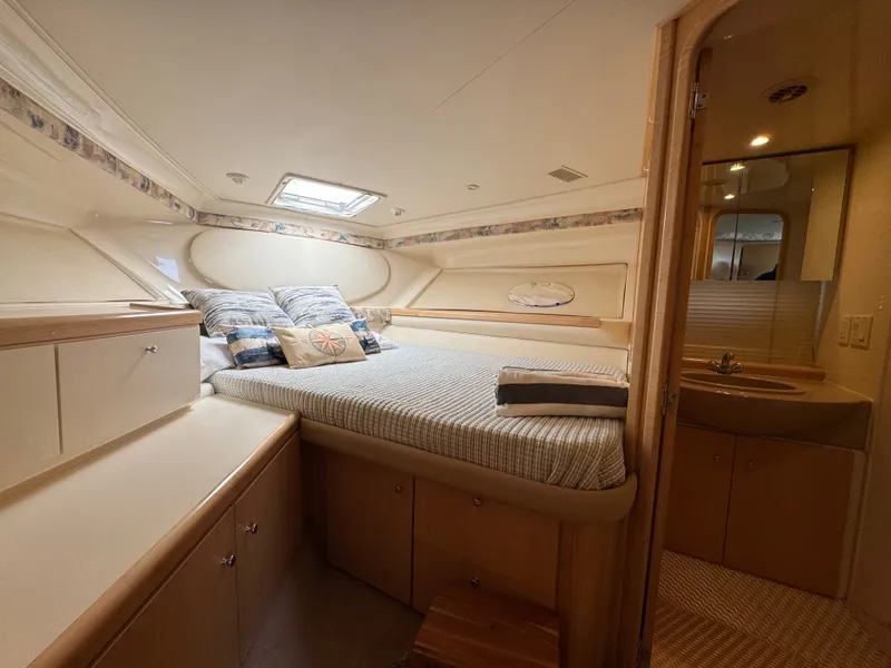 Slide: The Image of Interior of a 1998 Carver 35 with a cozy bed and storage space. - 21