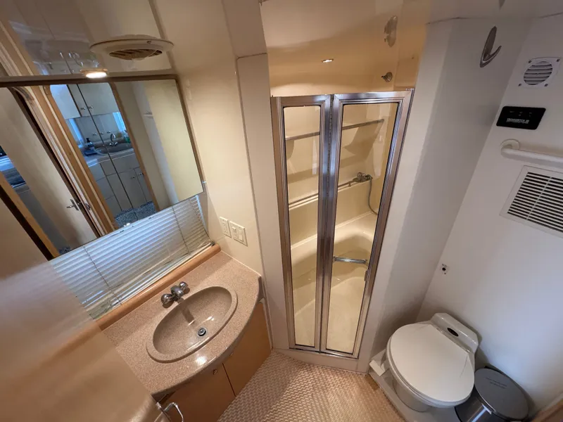 Slide: The Image of Bathroom in a 1998 Carver 35 yacht with sink, toilet, and shower. - 25