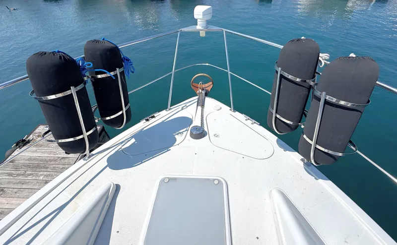 Slide: The Image of Bow view of the 1998 Carver 35 with fenders and blue water. - 4