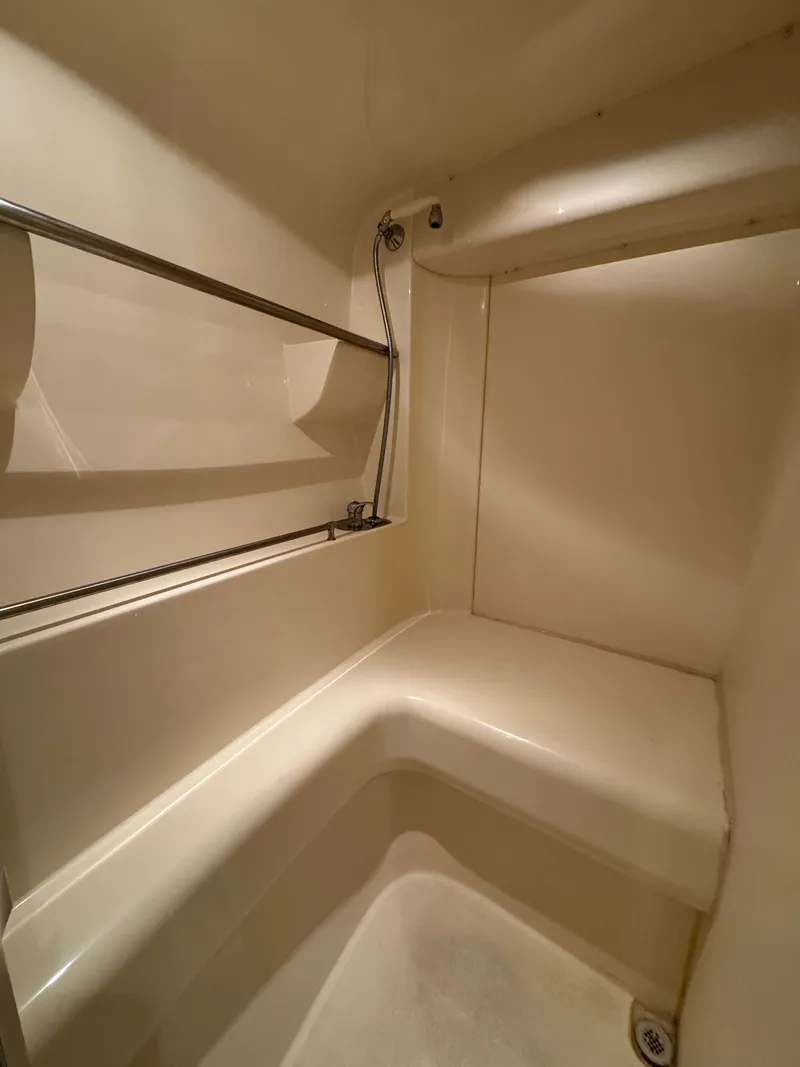Slide: The Image of Interior of a 1998 Carver 35 featuring a shower and towel rack. - 26