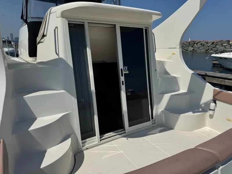 Slide: The Image of The 1998 Carver 35 features a spacious aft deck with stairs and sliding glass doors. - 5