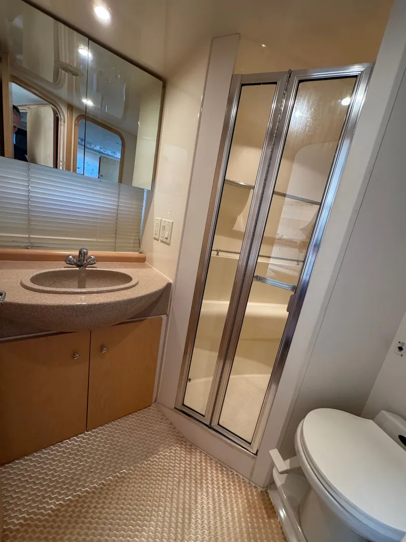 Slide: The Image of Bathroom with sink, shower, and toilet in a 1998 Carver 35 boat. - 24