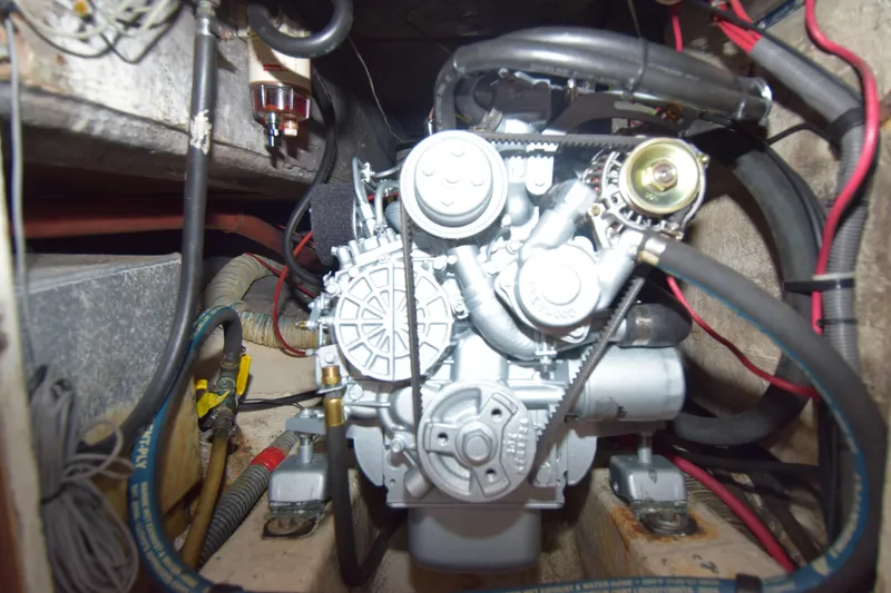 Slide: The Image of Engine compartment of a 1991 Catalina 38 sailboat, showcasing mechanical components and wiring. - 12