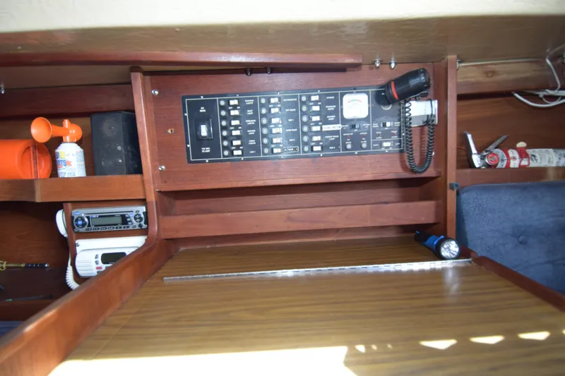 Slide: The Image of Interior view of a 1991 Catalina 38 sailboat featuring control panel and equipment storage. - 8