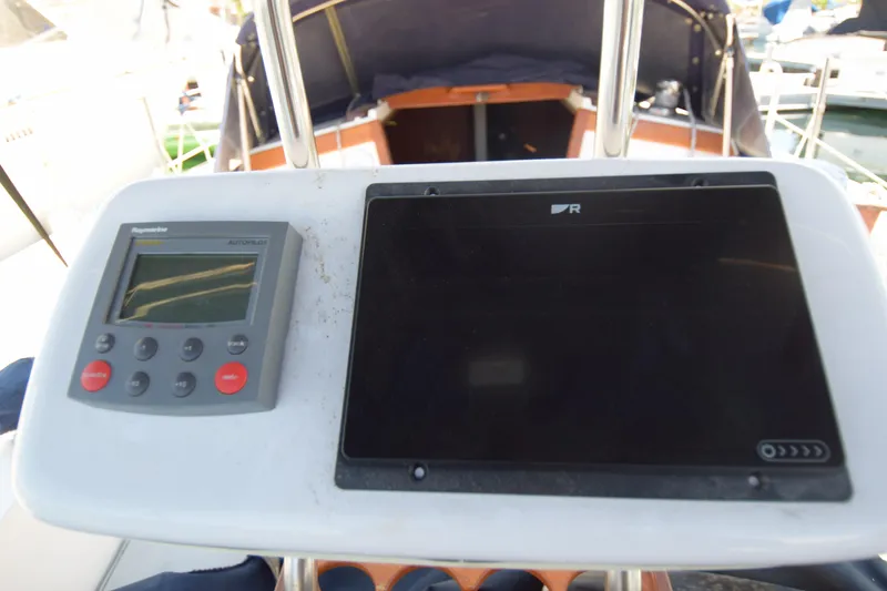 Slide: The Image of Cockpit controls of a 1991 Catalina 38 sailboat, featuring navigation instruments. - 14