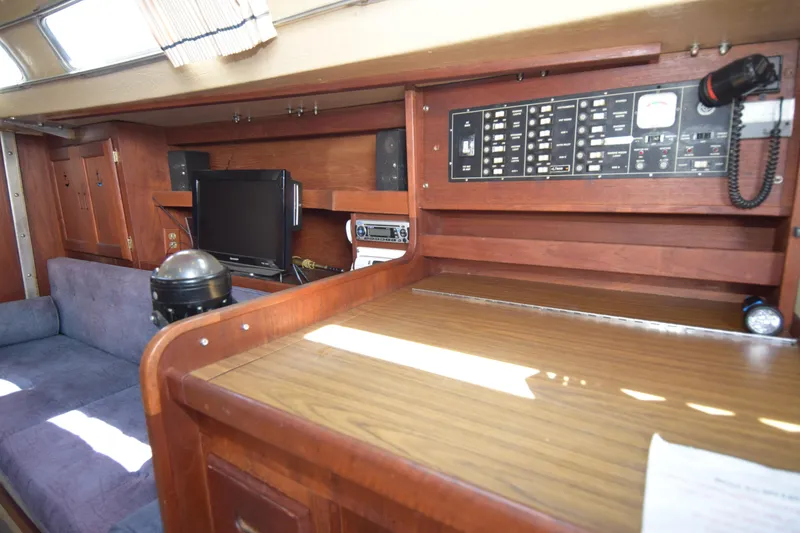 Slide: The Image of Interior of 1991 Catalina 38 sailboat with control panel and seating area. - 1