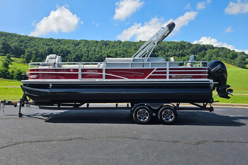 The Image of 2024 Ranger Reata 220FC pontoon boat on trailer, scenic background. - 1