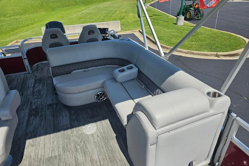 Slide: The Image of 2024 Ranger Reata 220FC boat interior with gray seating and cup holders. - 14