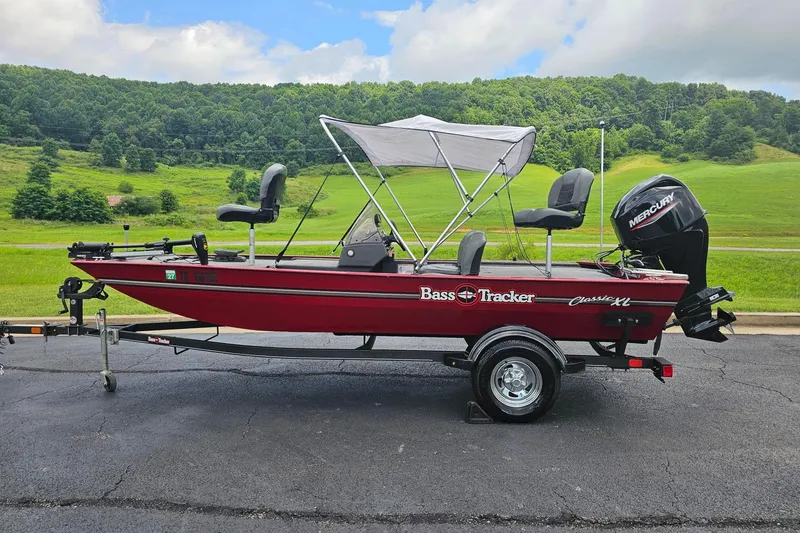 The Image of 2020 Tracker Bass Tracker Classic XL boat with canopy on trailer, scenic background. - 1