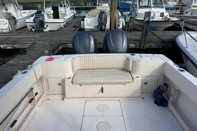 Slide: The Image of 2005 Grady-White Gulfstream 232 boat interior at dock, featuring seating and twin engines. - 11