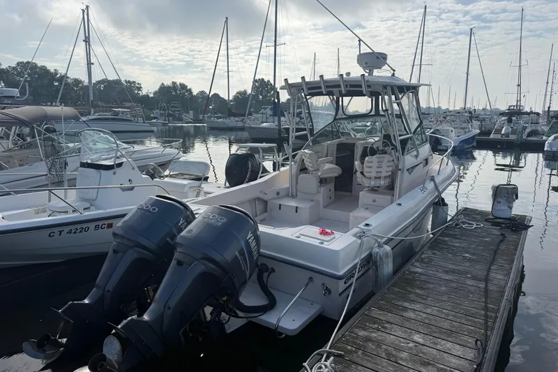 Slide: The Image of 2005 Grady-White Gulfstream 232 boat docked at marina with twin Yamaha engines. - 10