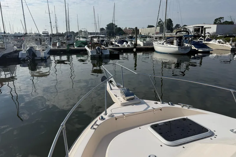 Slide: The Image of Bow view of a 2005 Grady-White Gulfstream 232 in a marina with various boats. - 5