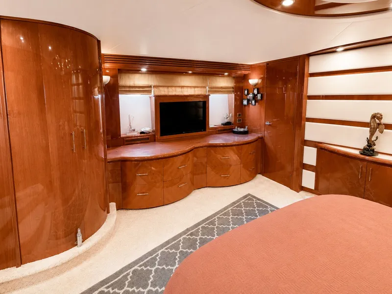 Slide: The Image of Luxurious interior of a 2006 Marquis 65 yacht with elegant wood furnishings and a flat-screen TV. - 33