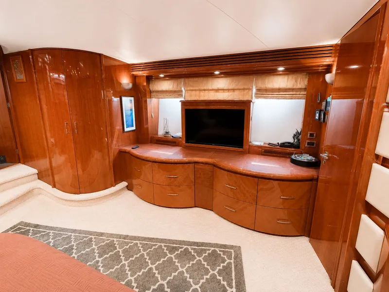 Slide: The Image of Luxurious interior of a 2006 Marquis 65 yacht with elegant wood furnishings and a large TV. - 35