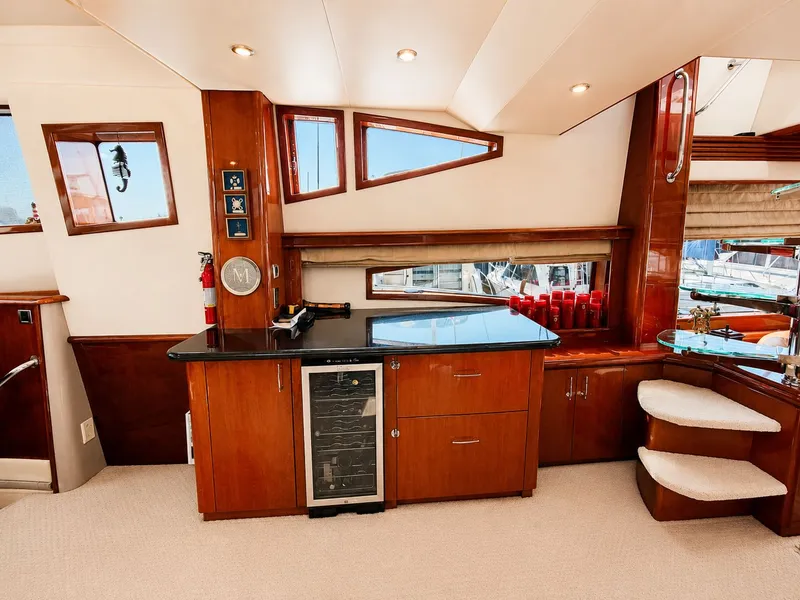 Slide: The Image of Interior of a 2006 Marquis 65 with elegant wood finishes and a small bar area. - 10