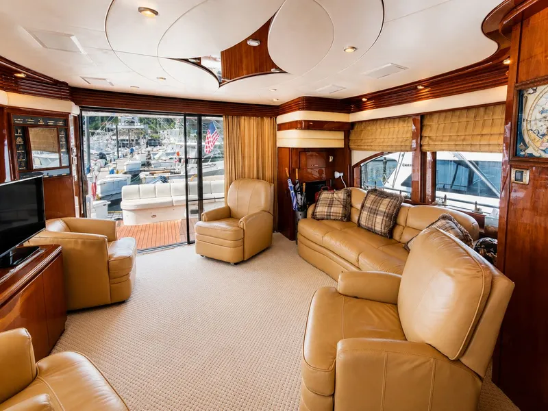 Slide: The Image of Luxurious salon with leather chairs and sofa, large windows, and marina view. - 16