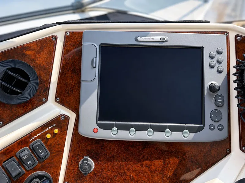 Slide: The Image of The image shows a navigation system on a boat with wood paneling. - 41