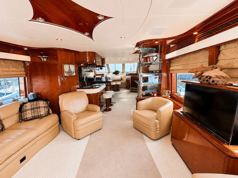 Slide: The Image of Luxurious salon of a 2006 Marquis 65 yacht with leather chairs and large windows. - 4